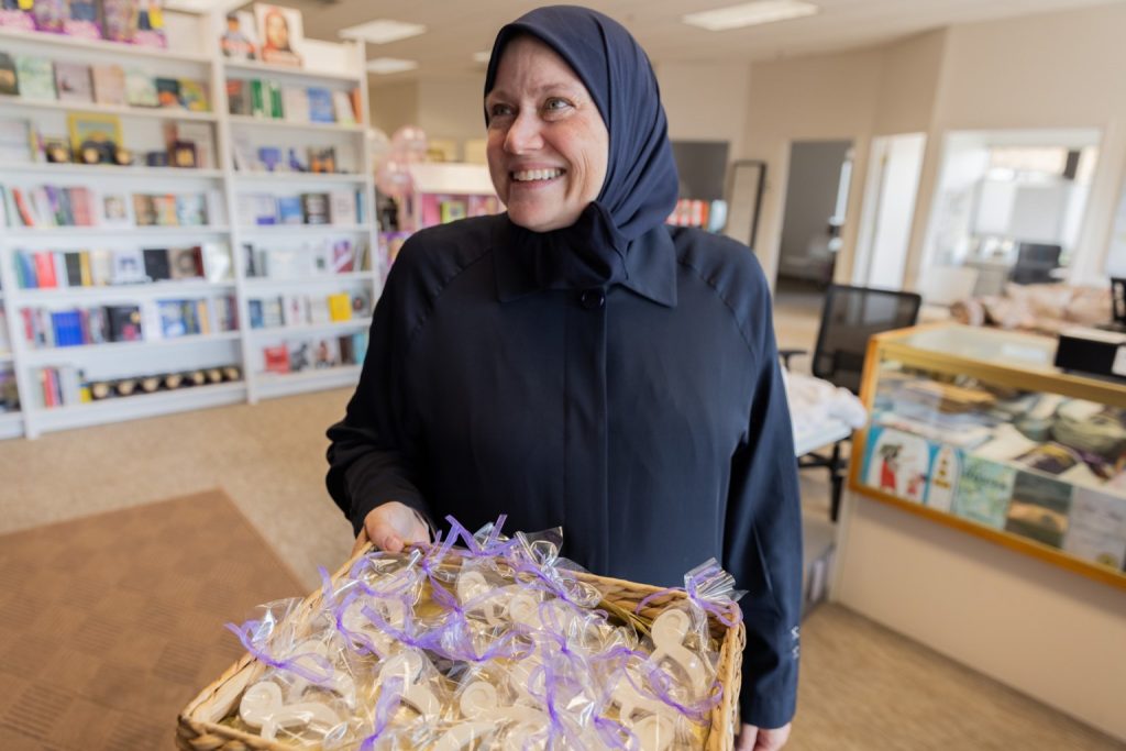 Tamara Gray holds a basket of treats in the store for Daybreak Press, her Minnesota-based publishing company for Muslim books.