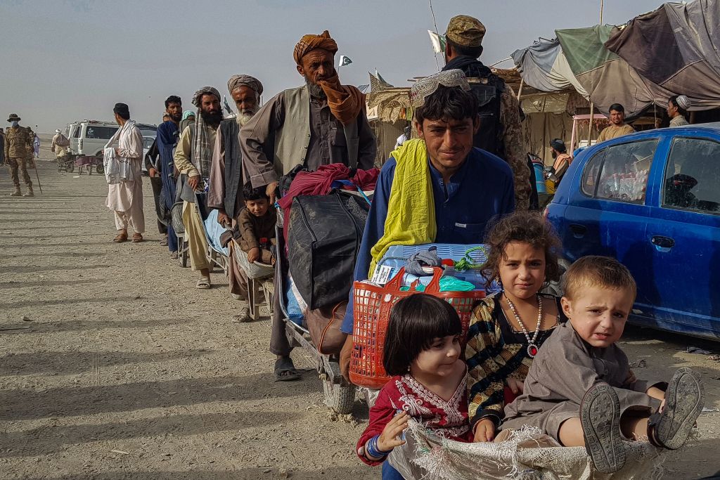 Afghan nationals queue up at the Pakistan-Afghanistan border crossing point in Chaman on August 17, 2021 to return back to Afghanistan. (Photo by – / AFP) (Photo by -/AFP via Getty Images)