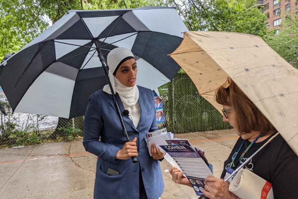 Manhattan District Attorney candidate Tahanie Aboushi speaks with a voter outside P.S. 163 on the Upper West Side Tuesday afternoon, June 22, 2021. Rachel Holliday Smith/THE CITY