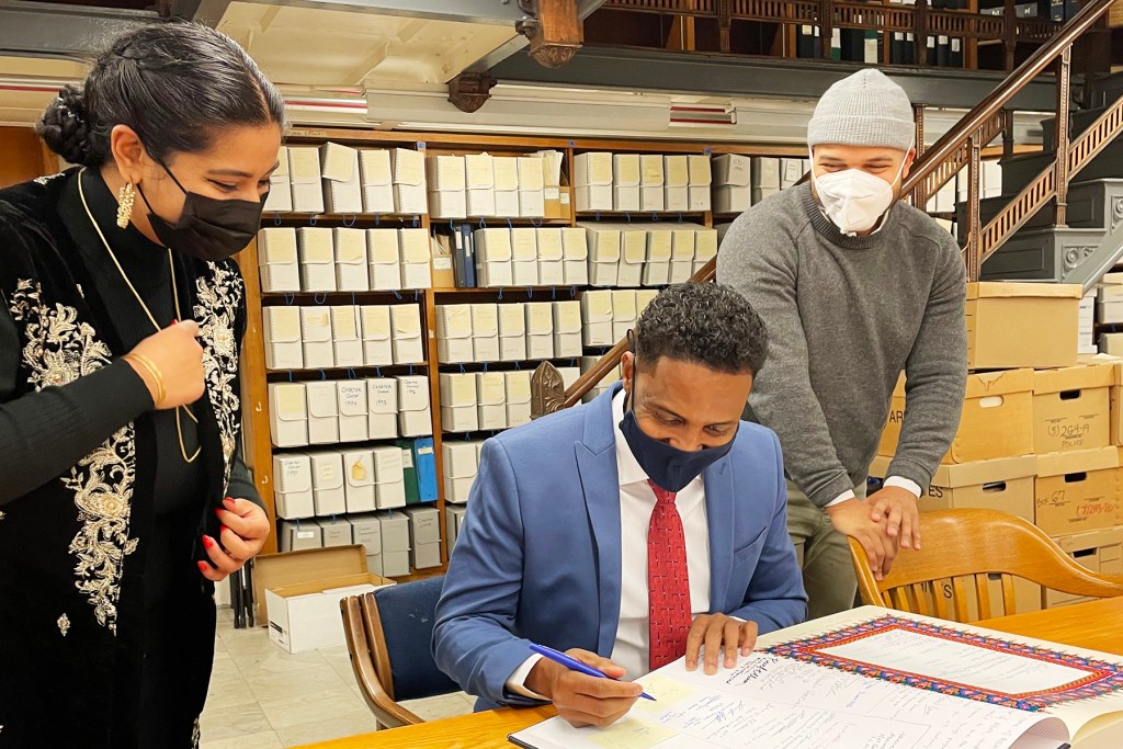 Jamal Osman, who represents Ward 6 in Minneapolis, signed the ceremonial Qur’an used during his swearing in ceremony on January 3, 2022. Credit: Imam Asad Zaman | Muslim American Society of Minnesota