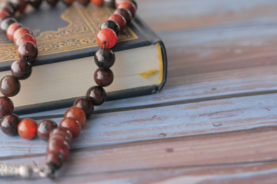 Quran and Rosary on Table