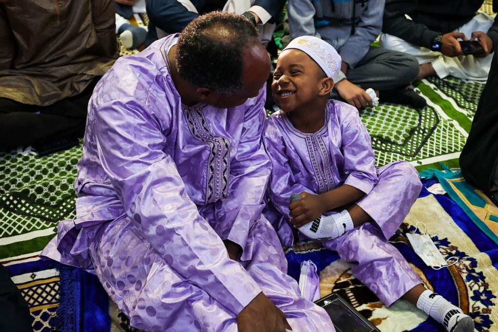 A Muslim man looks at his son as Eid al-Fitr is celebrated at the Teaneck National Guard Armory in Teaneck, New Jersey, – Tayfun Coskun / Anadolu Agency / Getty