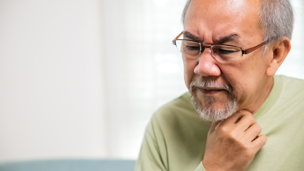 Asian old man painful in the sore throat