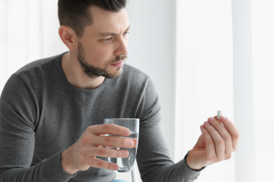 Man taking medicine pill-Does Taking Medicine after Fajr Break Your Fast?