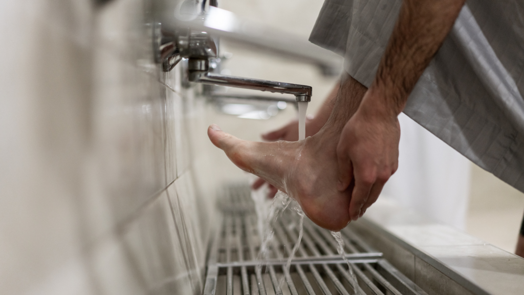 muslim man washing his feet-Sunnah Acts of Wudu