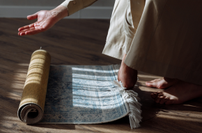 Muslim rolling out a prayer rug-Importance of prayer in Islam