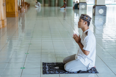 Muslim man praying in the mosque -time of zuhr prayer