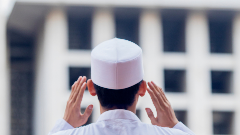 Young muslim man giving adhan in mosque -Discover the Virtues of Adhan in Islam