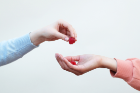 hand giving raspberry