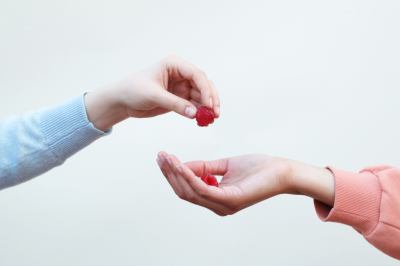 hand giving raspberry