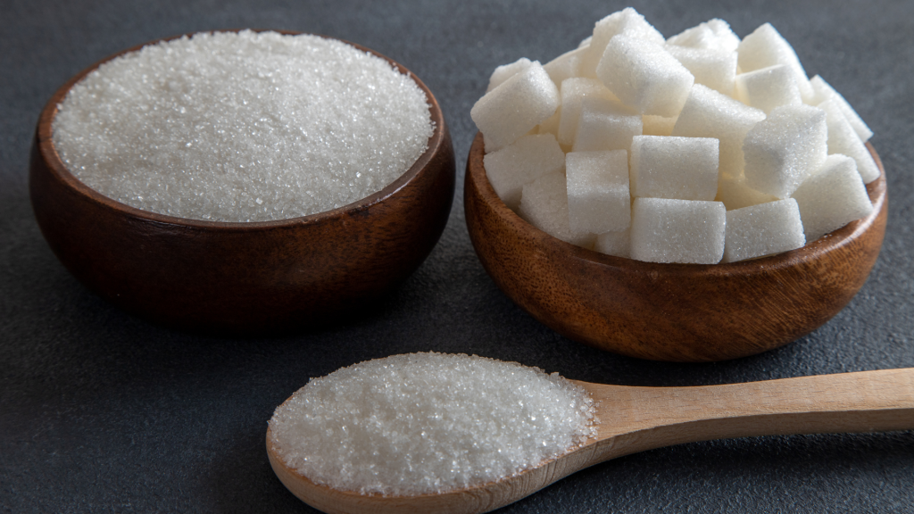 cubes and granulated sugar on blackground-Is Sugar Alcohol Halal?