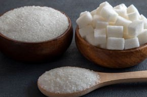 cubes and granulated sugar on blackground-Is Sugar Alcohol Halal?