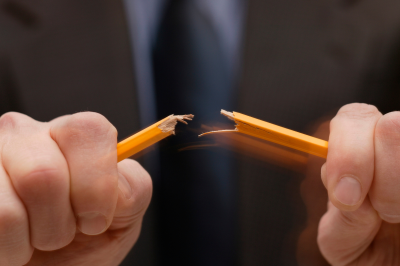 a man breaking a pencil
