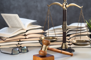 Law and Justice Symbols with law books on background. Law concept image