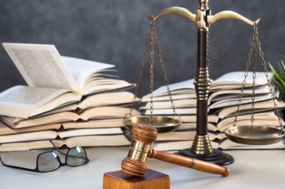 Law and Justice Symbols with law books on background. Law concept image