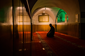 a person praying in a mosque