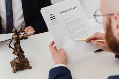 a person holding divorce decree document-One Talaq Given: Can a Wife Leave the Marital Home?-One Talaq Given: Can a Wife Leave the Marital Home?