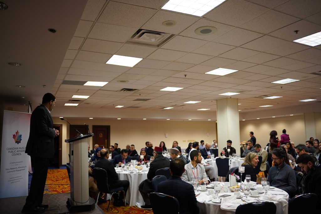 Khaled Al-Qazzaz, Executive Director of the Canadian Muslim Public Affairs Council, addresses a room with Members of Parliament, government staff, and community leaders about the contributions of Canadian Muslims.